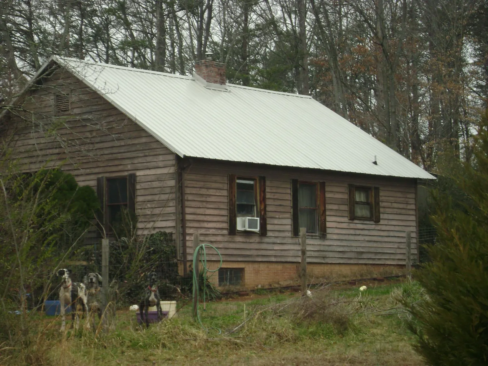 White metal roof on an old wood sided farmhouse, from a Metal Roof Installation job in Toppenish